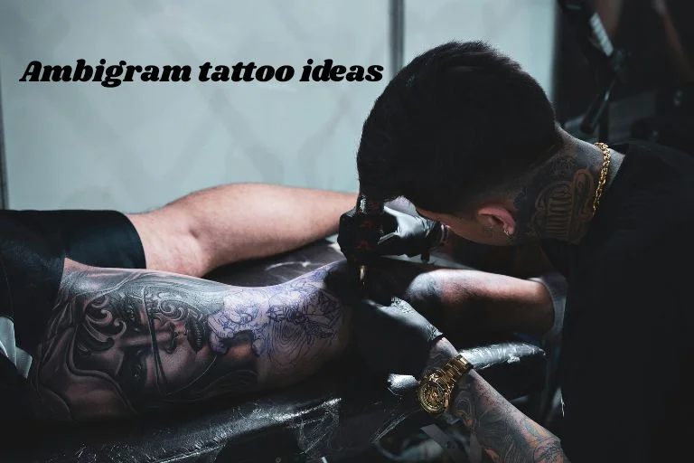 A tattoo artist inking a detailed arm sleeve — ambigram tattoo ideas for words and names